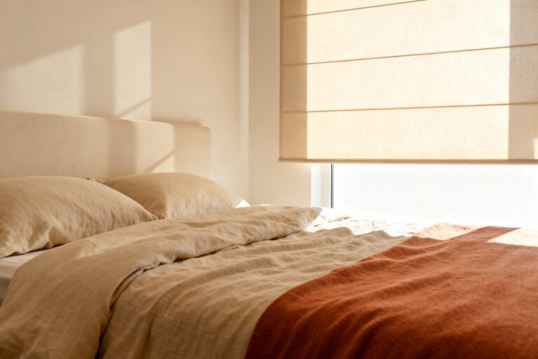 Calm bedroom where light-filtering shades and a blackout curtain soften daylight